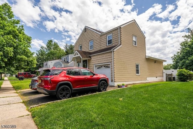 896 Maurice Ave, Rahway City, NJ 07065 - view of side of property featuring asphalt driveway, a garage, and a yard