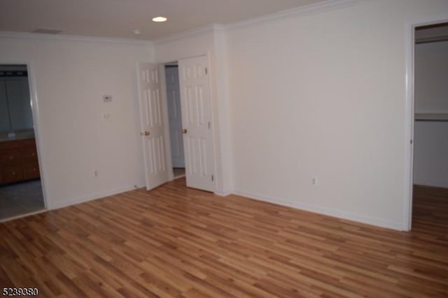 12 Hudson Dr, Bernards Twp, NJ 07920 - unfurnished bedroom featuring wood finished floors, crown molding, recessed lighting, baseboards, and connected bathroom