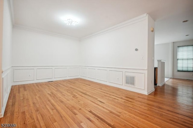 12 Hudson Dr, Bernards Twp, NJ 07920 - empty room with light wood-style flooring, crown molding, wainscoting, and a decorative wall