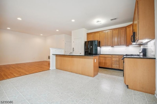 12 Hudson Dr, Bernards Twp, NJ 07920 - kitchen with black appliances, a sink, recessed lighting, a center island with sink, and brown cabinets