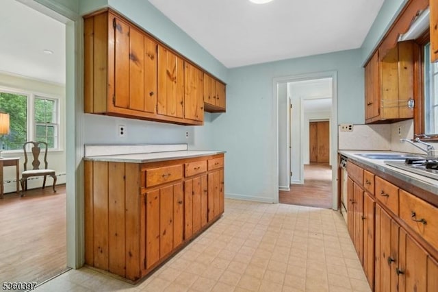 6 Emery Ave, Mendham Boro, NJ 07945 - kitchen featuring brown cabinetry, light countertops, a baseboard radiator, baseboards, and light floors