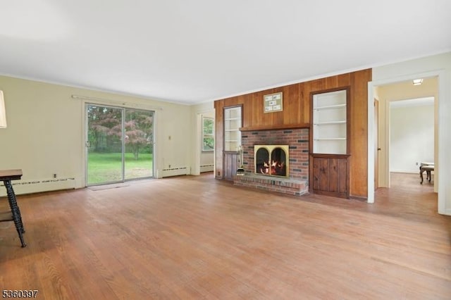 6 Emery Ave, Mendham Boro, NJ 07945 - unfurnished living room featuring a baseboard heating unit, crown molding, wood finished floors, a brick fireplace, and built in features