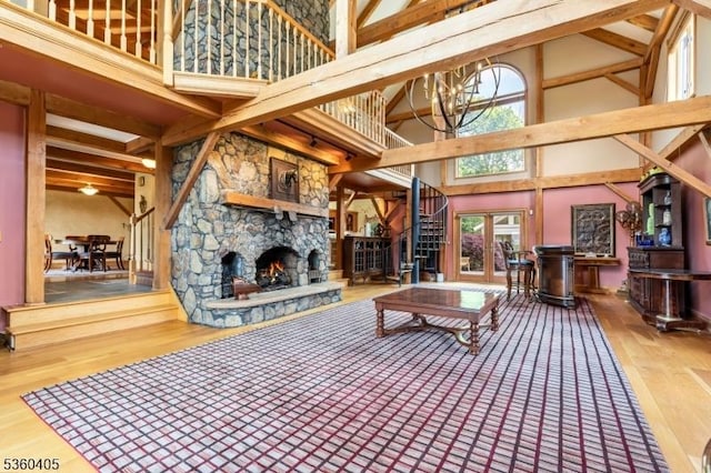 2 Sunset Farm Ln, Lebanon Twp, NJ 08826 - living area with a high ceiling, stairway, wood finished floors, a stone fireplace, and healthy amount of natural light