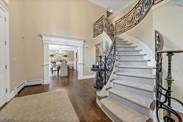 325 Hobar Ct, Franklin Lakes Boro, NJ 07417 - foyer entrance with ornate columns, ornamental molding, wood finished floors, stairway, and a chandelier