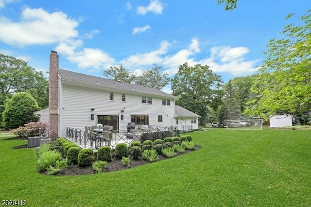 325 Hobar Ct, Franklin Lakes Boro, NJ 07417 - back of property with a chimney, a yard, and central AC