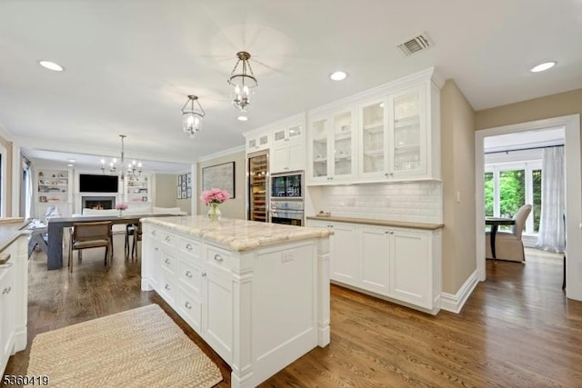 325 Hobar Ct, Franklin Lakes Boro, NJ 07417 - kitchen with a chandelier, stainless steel oven, dark wood finished floors, white cabinetry, and black microwave