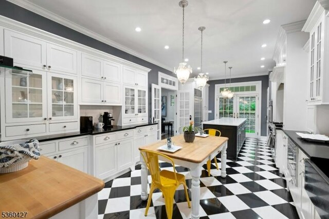 151 Hurd St, Mine Hill Twp, NJ 07803 - kitchen with tile patterned floors, white cabinetry, a center island, ornamental molding, and hanging light fixtures