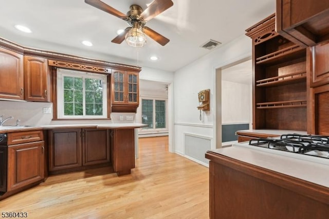 8 Pine Tree Ter, Madison Boro, NJ 07940 - kitchen featuring light countertops, light wood-style flooring, ceiling fan, a sink, and wainscoting