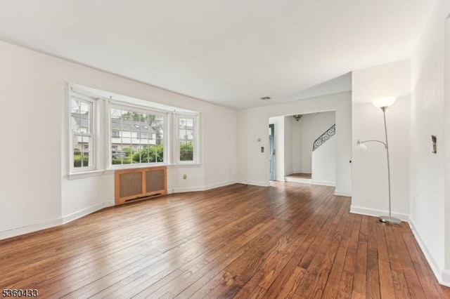 8 Pine Tree Ter, Madison Boro, NJ 07940 - spare room featuring radiator heating unit, hardwood / wood-style flooring, baseboards, and stairs