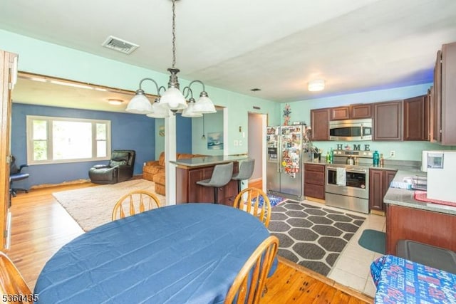 110 Shore Rd, Green Twp, NJ 07821 - dining room with a chandelier and light wood-style flooring