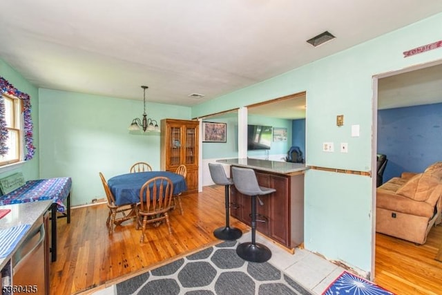 110 Shore Rd, Green Twp, NJ 07821 - dining space featuring light wood-style floors and a chandelier