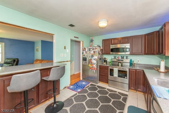 110 Shore Rd, Green Twp, NJ 07821 - kitchen featuring stainless steel appliances, a breakfast bar area, and light countertops