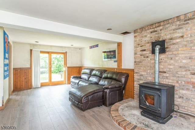 110 Shore Rd, Green Twp, NJ 07821 - living area featuring a wainscoted wall, wood finished floors, a wood stove, and wood walls