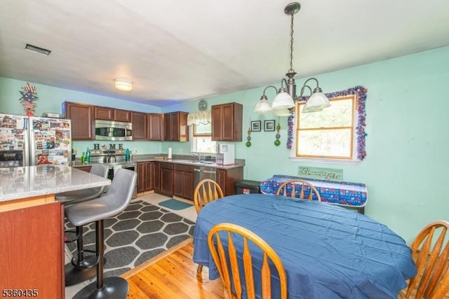 110 Shore Rd, Green Twp, NJ 07821 - dining space with a chandelier and light wood-style flooring