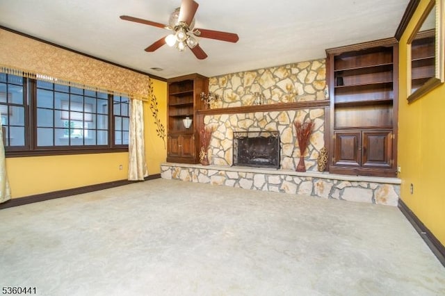 60 Queens Rd, Rockaway Twp, NJ 07866 - unfurnished living room with carpet floors, a ceiling fan, baseboards, a stone fireplace, and built in shelves