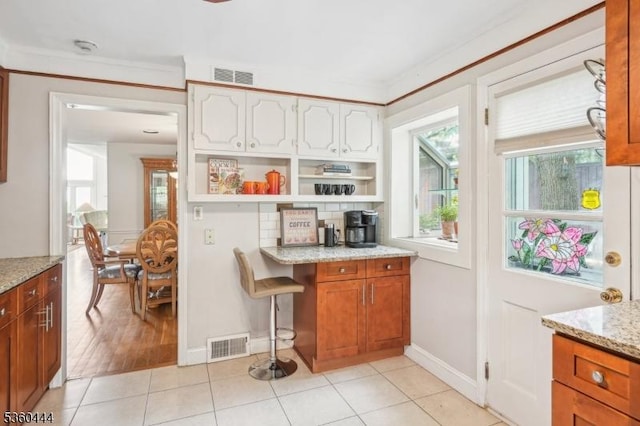 12 Beaumont Ter, West Orange Twp, NJ 07052 - kitchen featuring open shelves, light stone countertops, plenty of natural light, and baseboards