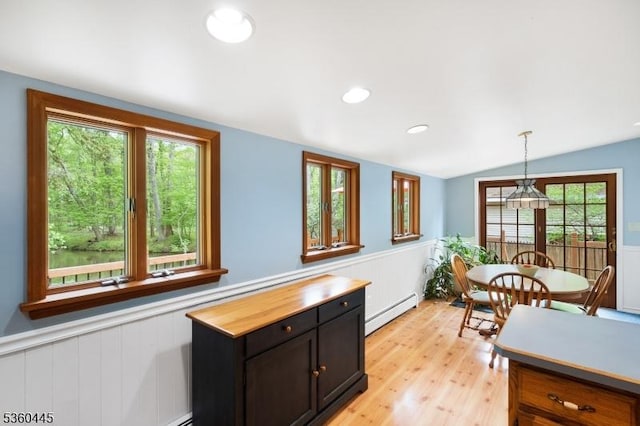 624 New St, River Vale Twp, NJ 07675 - kitchen featuring baseboard heating, light wood-style flooring, vaulted ceiling, wainscoting, and decorative light fixtures