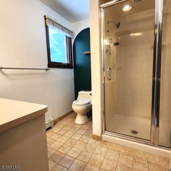 161 Neilson Rd, Wantage Twp, NJ 07461 - full bath featuring baseboard heating, vanity, a stall shower, toilet, and baseboards