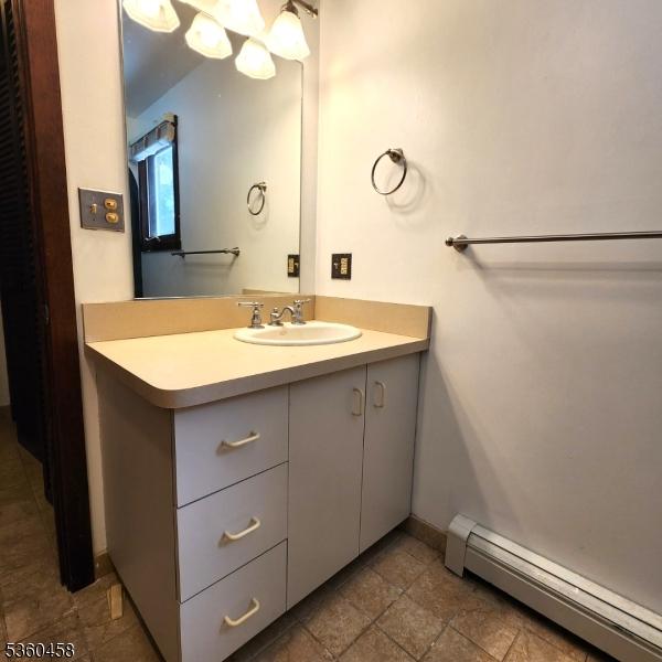 161 Neilson Rd, Wantage Twp, NJ 07461 - bathroom featuring baseboard heating, vanity, and baseboards