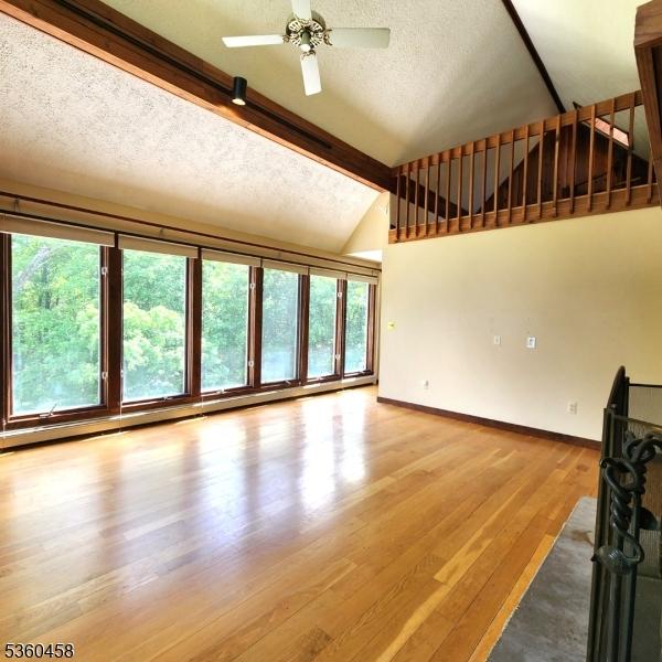 161 Neilson Rd, Wantage Twp, NJ 07461 - unfurnished living room featuring light wood-style flooring, baseboards, a textured ceiling, and ceiling fan