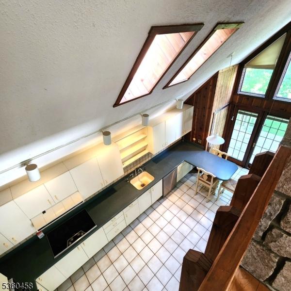 161 Neilson Rd, Wantage Twp, NJ 07461 - kitchen featuring lofted ceiling, a textured ceiling, tile patterned floors, dishwasher, and a sink