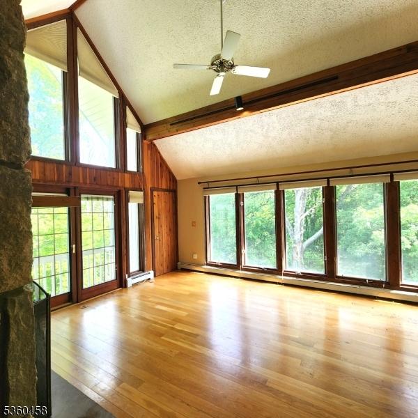 161 Neilson Rd, Wantage Twp, NJ 07461 - unfurnished living room featuring a textured ceiling, a baseboard radiator, light wood finished floors, a ceiling fan, and beam ceiling