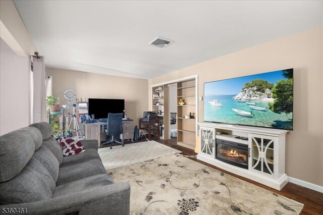 39 Hillside Ct, Union Twp, NJ 08809 - living room featuring wood finished floors, a desk, and a glass covered fireplace