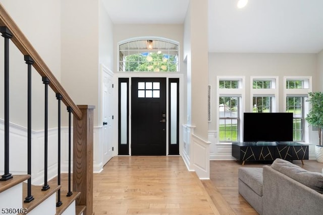 18 Hartley Ln, Bernards Twp, NJ 07920 - foyer featuring light wood-style flooring, stairs, a high ceiling, and a decorative wall