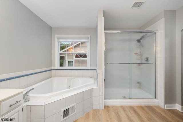 18 Hartley Ln, Bernards Twp, NJ 07920 - bathroom with a bath, a stall shower, and wood finished floors