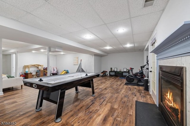 18 Hartley Ln, Bernards Twp, NJ 07920 - game room with a glass covered fireplace, wood finished floors, and a paneled ceiling