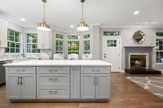 18 Hartley Ln, Bernards Twp, NJ 07920 - kitchen featuring gray cabinets, a sink, stainless steel dishwasher, crown molding, and light countertops
