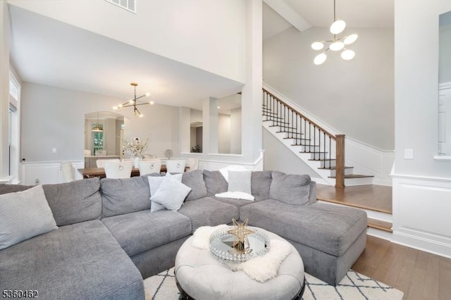 18 Hartley Ln, Bernards Twp, NJ 07920 - living area with a chandelier, hardwood / wood-style floors, beam ceiling, stairway, and a wainscoted wall