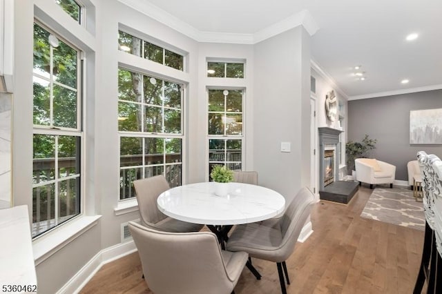 18 Hartley Ln, Bernards Twp, NJ 07920 - dining space featuring ornamental molding, a glass covered fireplace, wood finished floors, recessed lighting, and baseboards