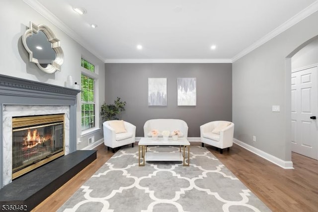 18 Hartley Ln, Bernards Twp, NJ 07920 - living area featuring wood finished floors, baseboards, a fireplace, crown molding, and arched walkways