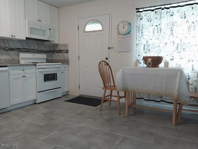 281 Reynolds Ter Unit 24, City Of Orange Twp, NJ 07050 - kitchen featuring white appliances, white cabinetry, and backsplash