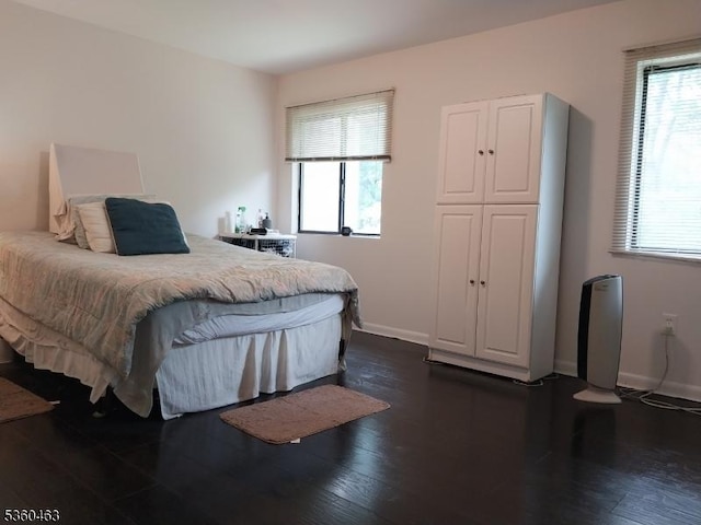 281 Reynolds Ter Unit 24, City Of Orange Twp, NJ 07050 - bedroom featuring multiple windows, baseboards, and dark wood-style floors