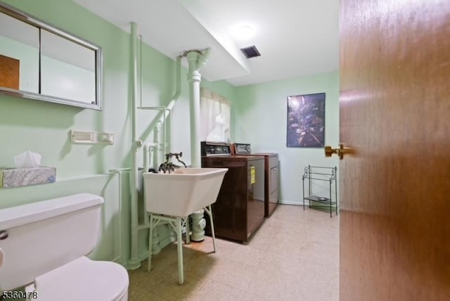 30 Fox Hill Rd, Fairfield Twp, NJ 07004 - bathroom with washer and dryer, tile patterned floors, and toilet