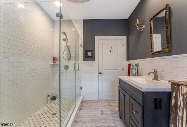 44 Main St, Califon Boro, NJ 07830 - full bathroom featuring tile walls, a stall shower, vanity, wood finished floors, and wainscoting