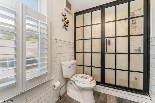 44 Main St, Califon Boro, NJ 07830 - bathroom with tile walls, a stall shower, and wood finished floors