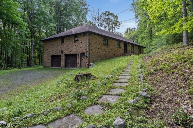 125 Free Union Rd, Liberty Twp, NJ 07823 - view of home's exterior with dirt driveway, brick siding, and a garage