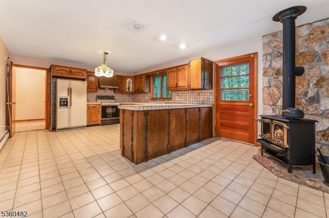 125 Free Union Rd, Liberty Twp, NJ 07823 - kitchen with white fridge with ice dispenser, electric stove, under cabinet range hood, a wood stove, and light tile patterned flooring