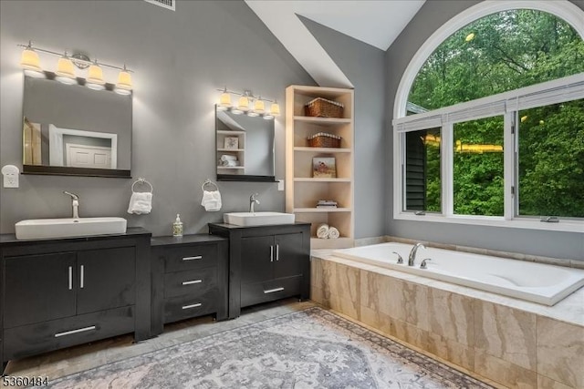 95 Underrock Rd, Sparta Twp, NJ 07871 - bathroom with two vanities, a garden tub, vaulted ceiling, and marble finish flooring