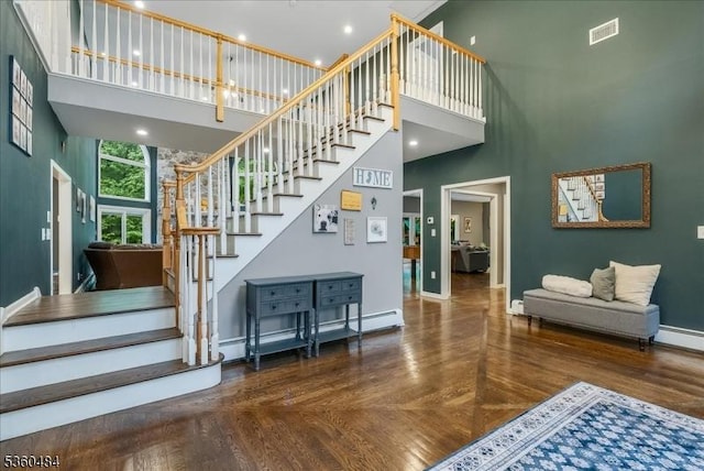 95 Underrock Rd, Sparta Twp, NJ 07871 - staircase with a high ceiling, baseboards, baseboard heating, a baseboard heating unit, and wood finished floors