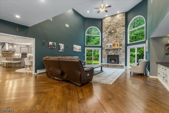 95 Underrock Rd, Sparta Twp, NJ 07871 - living room featuring high vaulted ceiling, a ceiling fan, a stone fireplace, baseboards, and wood finished floors