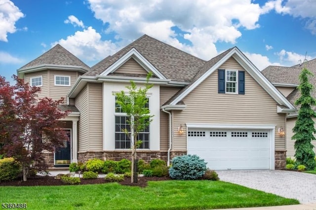 53 Patriots Way, Franklin Twp, NJ 08873 - view of front facade with stone siding, a garage, decorative driveway, and a front yard