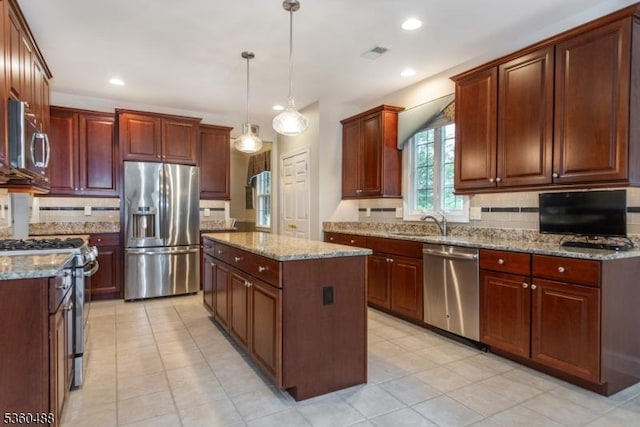 53 Patriots Way, Franklin Twp, NJ 08873 - kitchen featuring appliances with stainless steel finishes, a kitchen island, tasteful backsplash, light stone counters, and recessed lighting