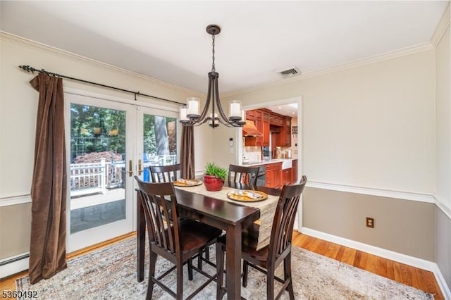 107 Shady Ln, Randolph Twp, NJ 07869 - dining space with light wood-type flooring, a chandelier, crown molding, a baseboard heating unit, and baseboards
