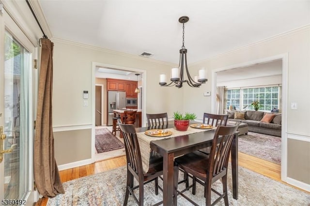 107 Shady Ln, Randolph Twp, NJ 07869 - dining room with a chandelier, light wood-type flooring, ornamental molding, and baseboards