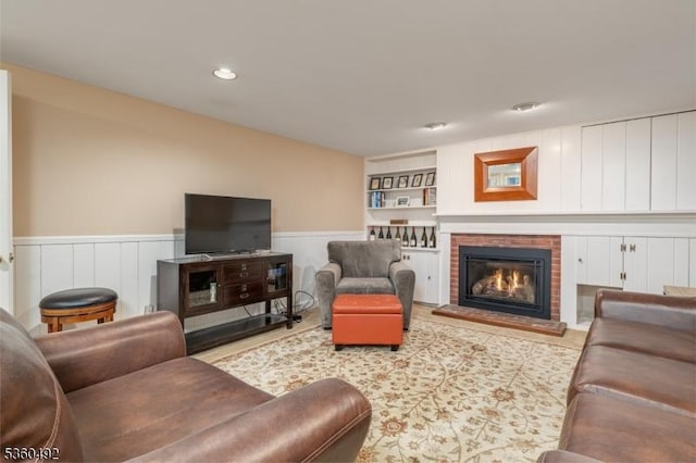 107 Shady Ln, Randolph Twp, NJ 07869 - living room featuring a wainscoted wall, a brick fireplace, and recessed lighting