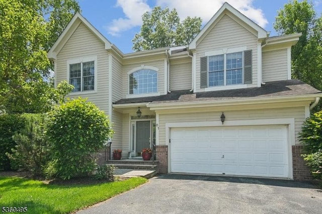 81 Schindler Way, Fairfield Twp, NJ 07004 - view of front of property with driveway, an attached garage, and brick siding